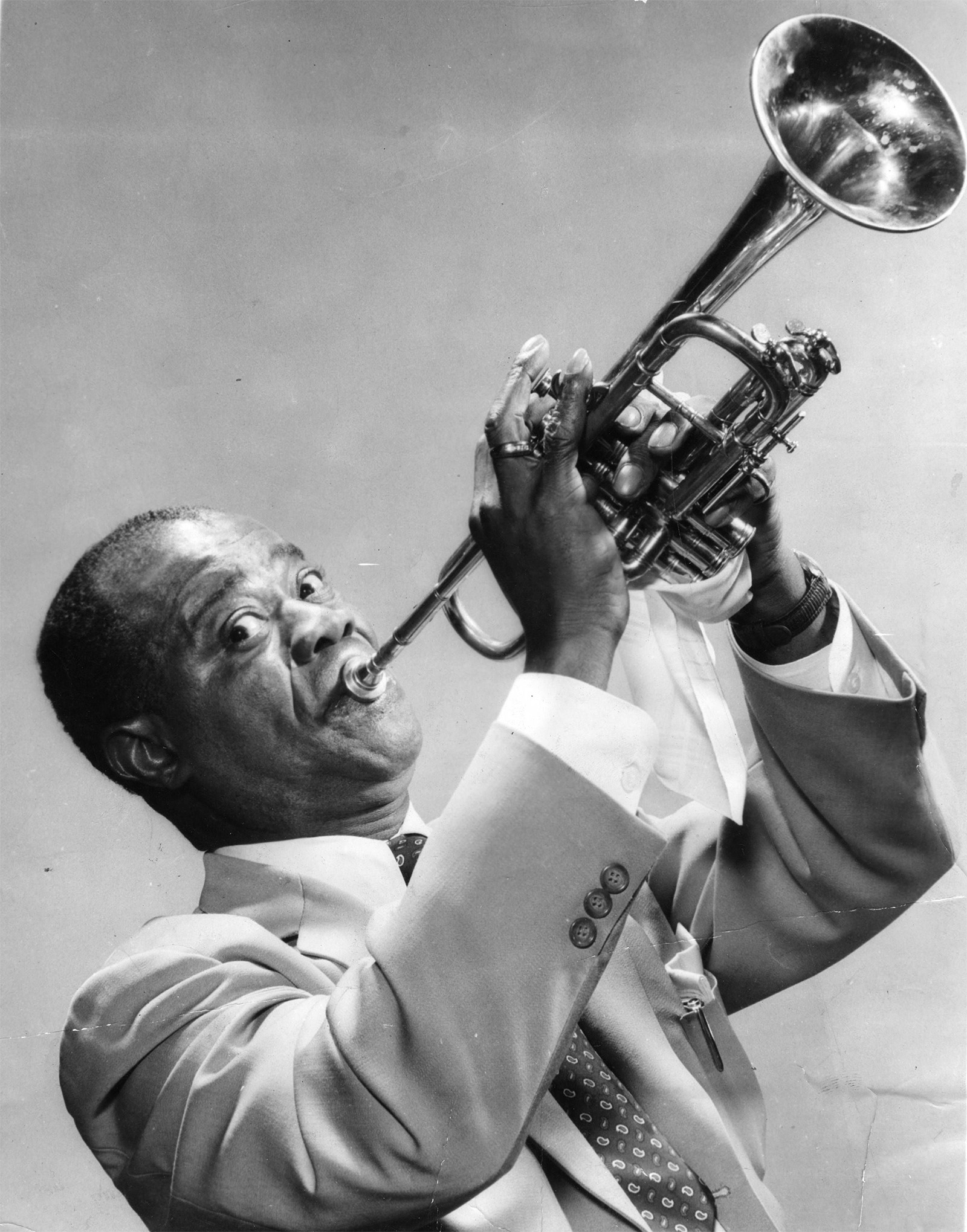 Louis Armstrong (trumpet raised)