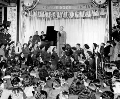 Bing Crosby entertains the troops at London's Stage Door Canteen